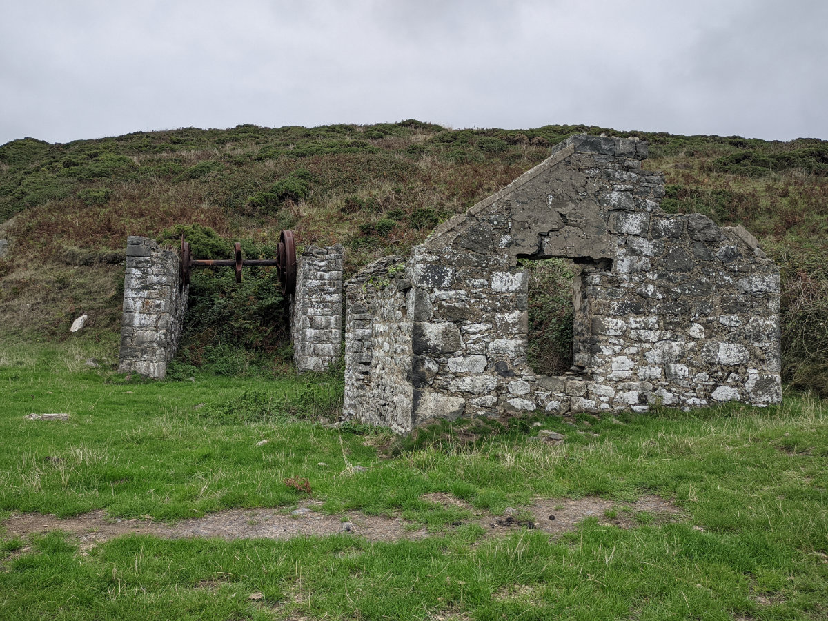 Old mine buildings dotted around the cliffs