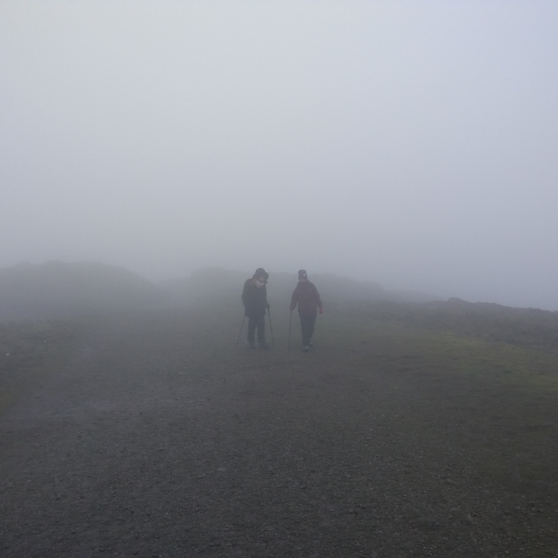 Hikers in dense fog